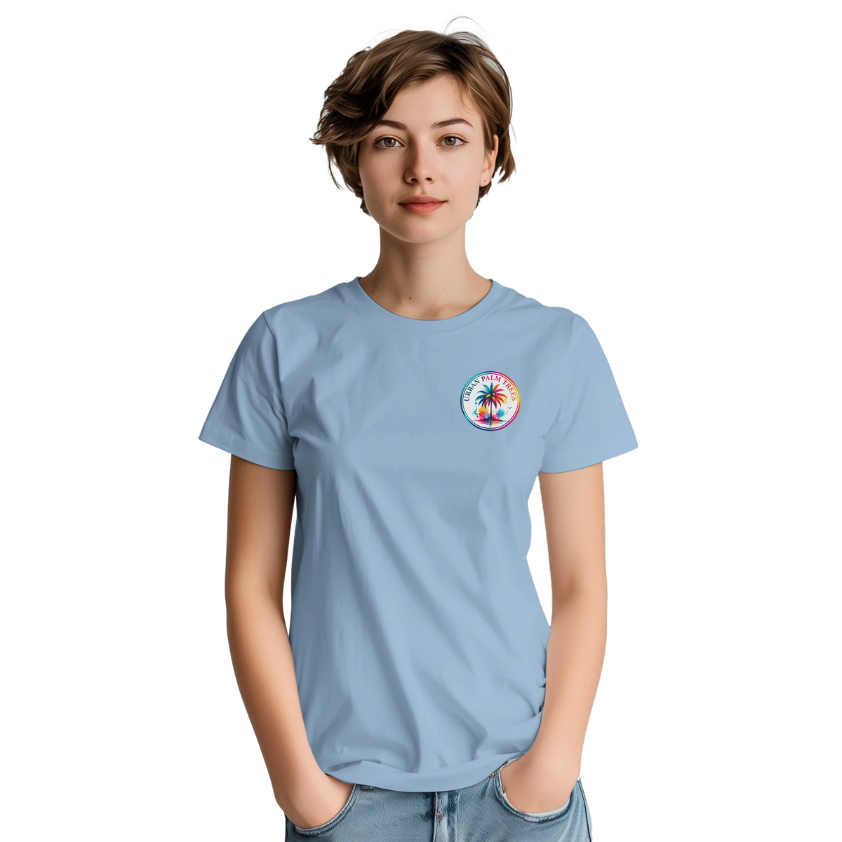 Woman wearing a light blue graphic tee featuring a colorful circular "Urban Palm Trees" logo on the chest.