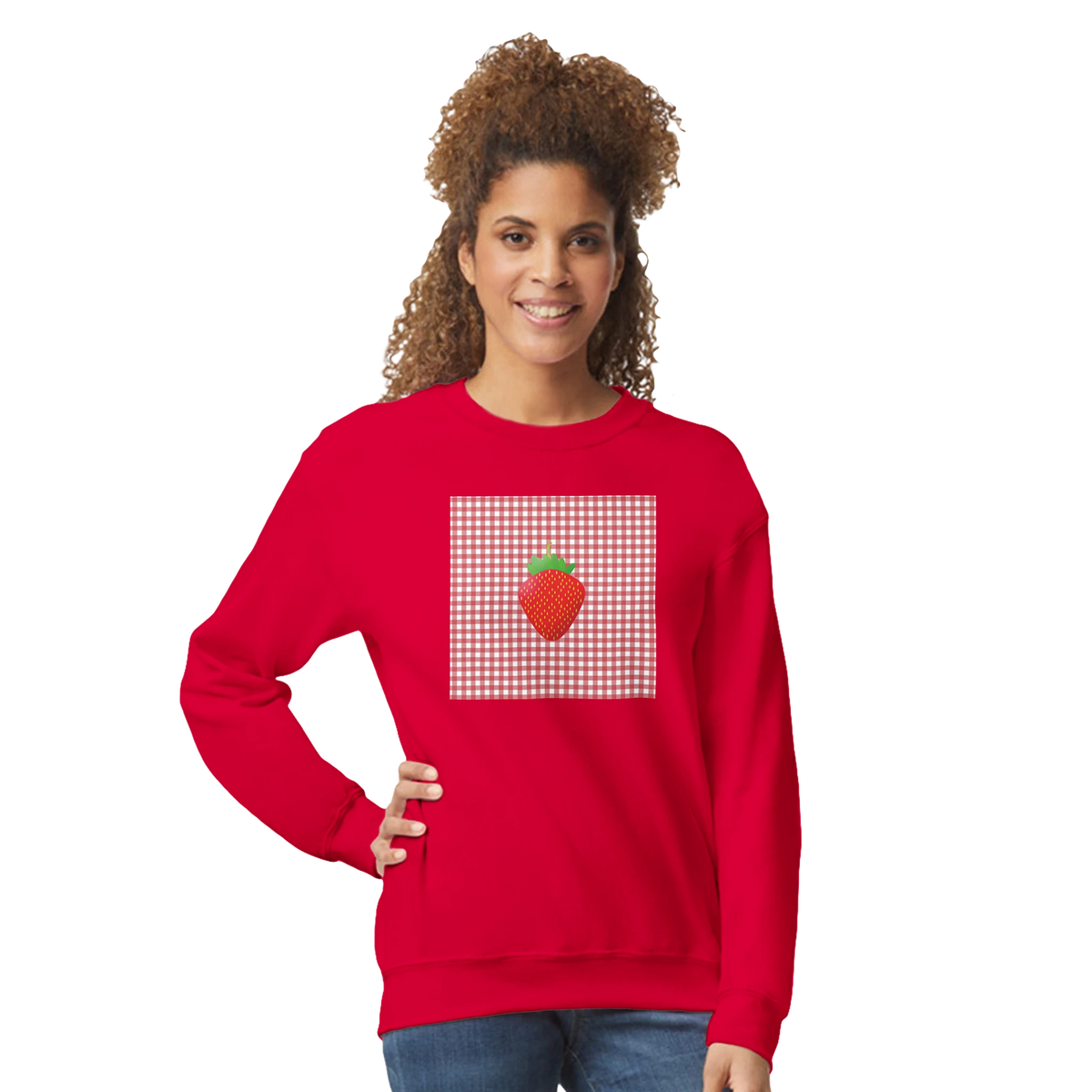 Woman wearing red Retro Strawberry Gingham Sweatshirt with strawberry graphic on gingham patch.