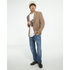 Male model in tan blazer wearing white Dab Teddy Bear graphic tee, blue jeans, beanie, casual streetwear.