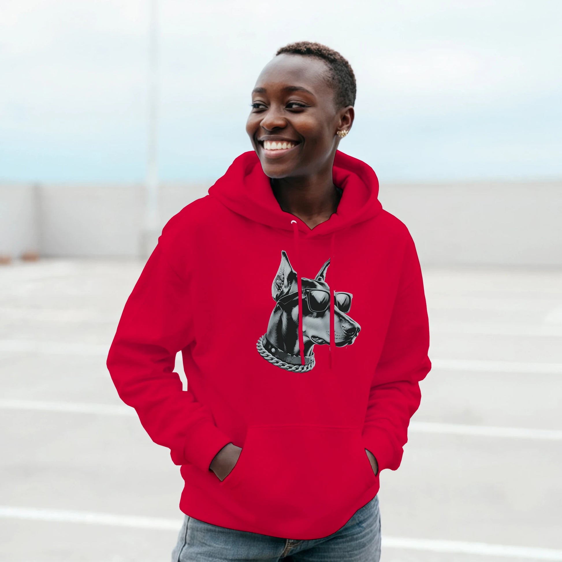 Smiling person in a red Gangster Dog Jumper hoodie, 50/50 cotton blend, featuring a dog with sunglasses and a chain.