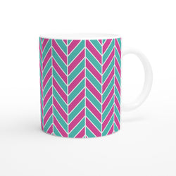 Pink and aqua ceramic coffee mug featuring a retro geometric herringbone pattern with a glossy finish.