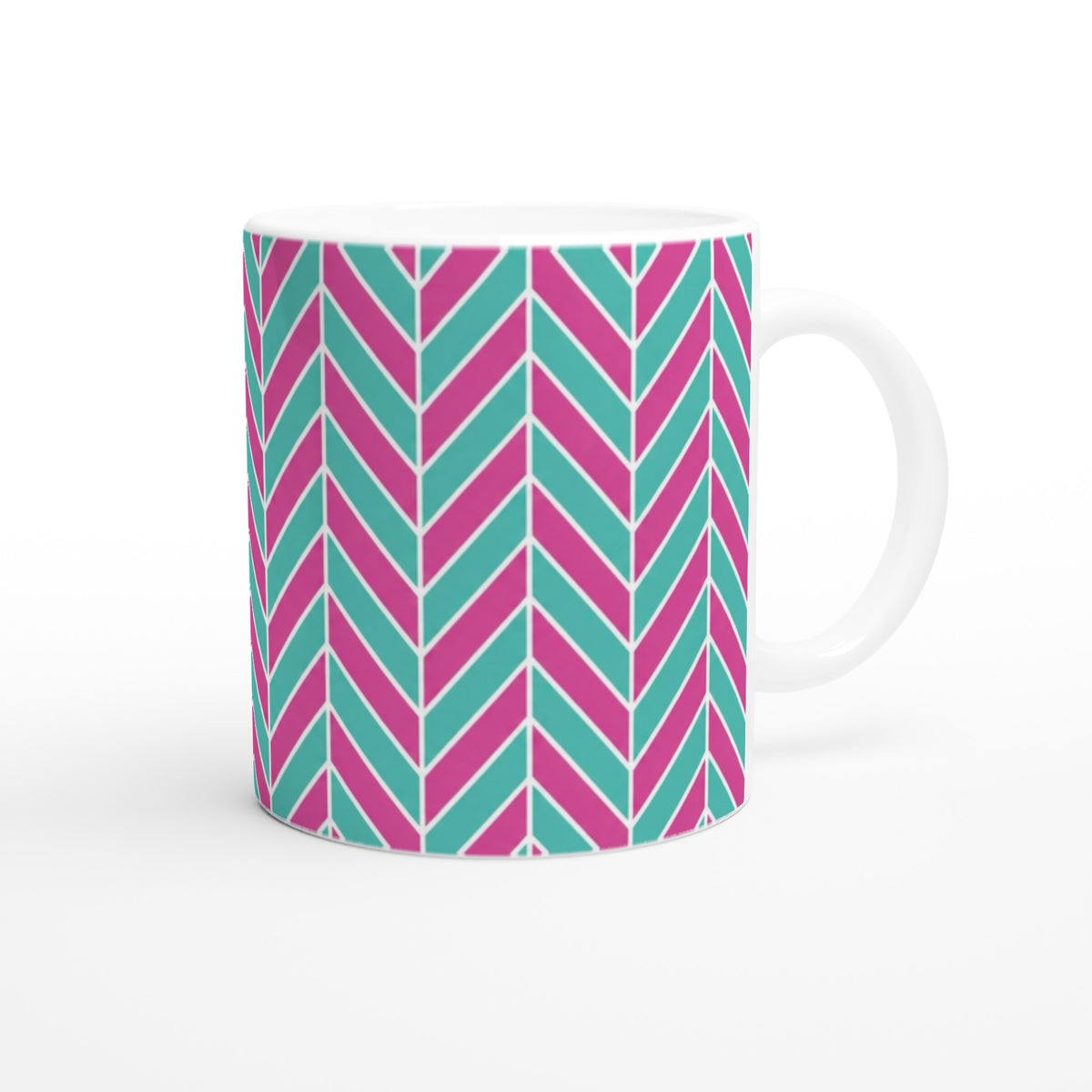 Pink and aqua ceramic coffee mug featuring a retro geometric herringbone pattern with a glossy finish.