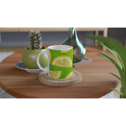 Lemon-slice mug with lime-green background and citrus wedge designs on a wooden table.
