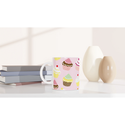 Cute Cupcake Mug - Pastel Kawaii ceramic coffee cup on a desk with notebooks and a lamp