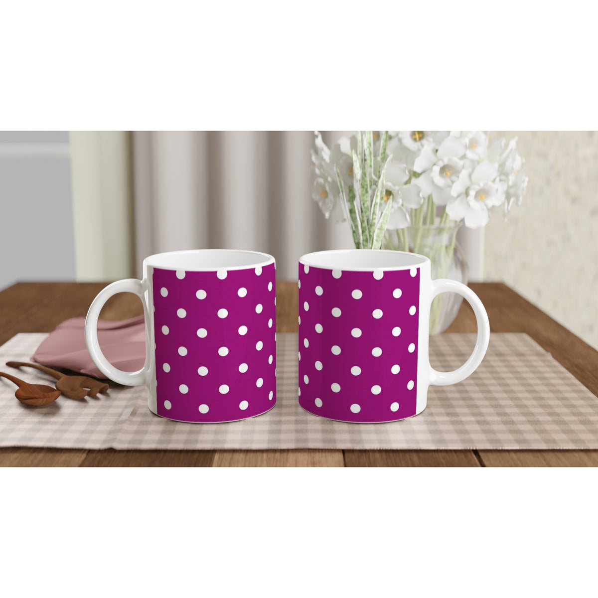 Two purple ceramic mugs with white polka dots sit on a checkered placemat, perfect for retro-style coffee or tea.
