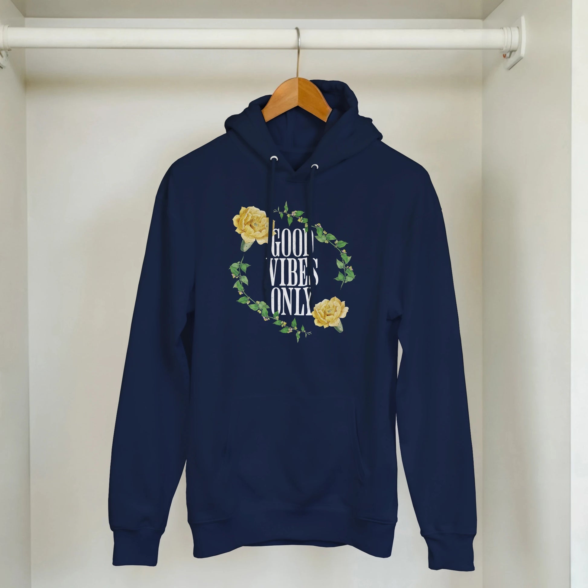Navy hoodie in a soft cotton blend with GOOD VIBES ONLY surrounded by yellow roses and green leaves, front pocket.