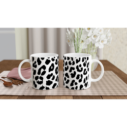 Retro Snow Leopard animal-print mugs on a checkered tablecloth in a cozy kitchen.