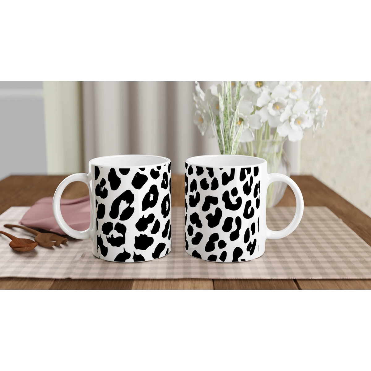 Retro Snow Leopard animal-print mugs on a checkered tablecloth in a cozy kitchen.