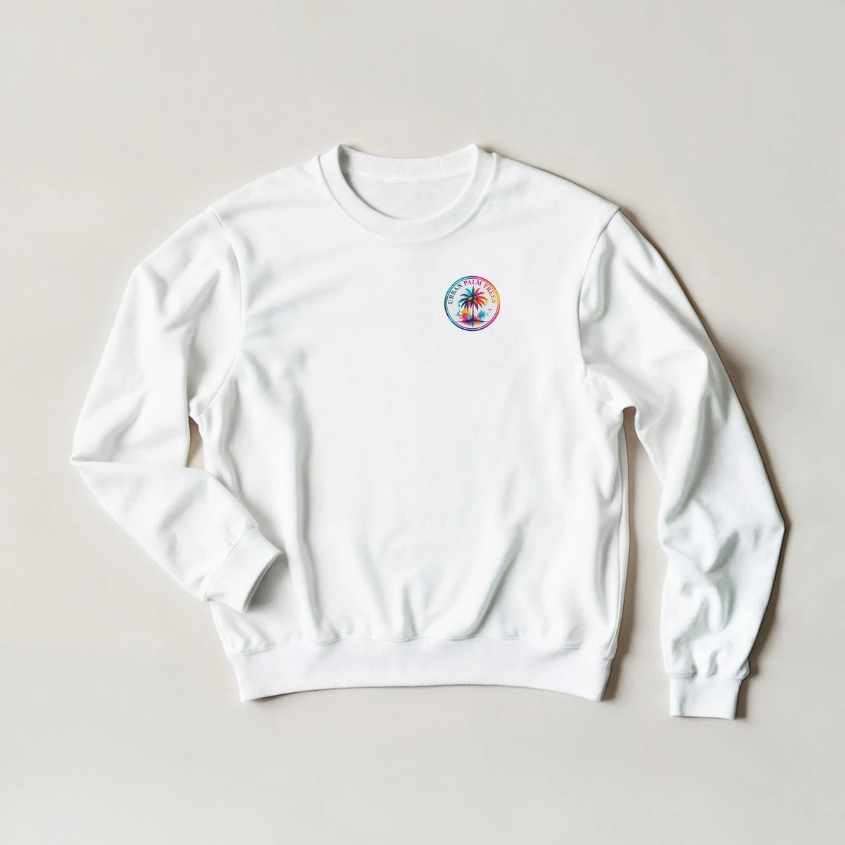 White crewneck sweatshirt featuring a colorful retro tropical palm tree logo on the chest for a cozy holiday vibe.