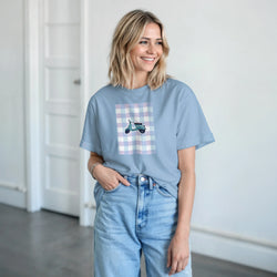 Pastel blue graphic tee featuring a retro scooter on a gingham background, styled with high-waisted denim jeans for a cute streetwear look.