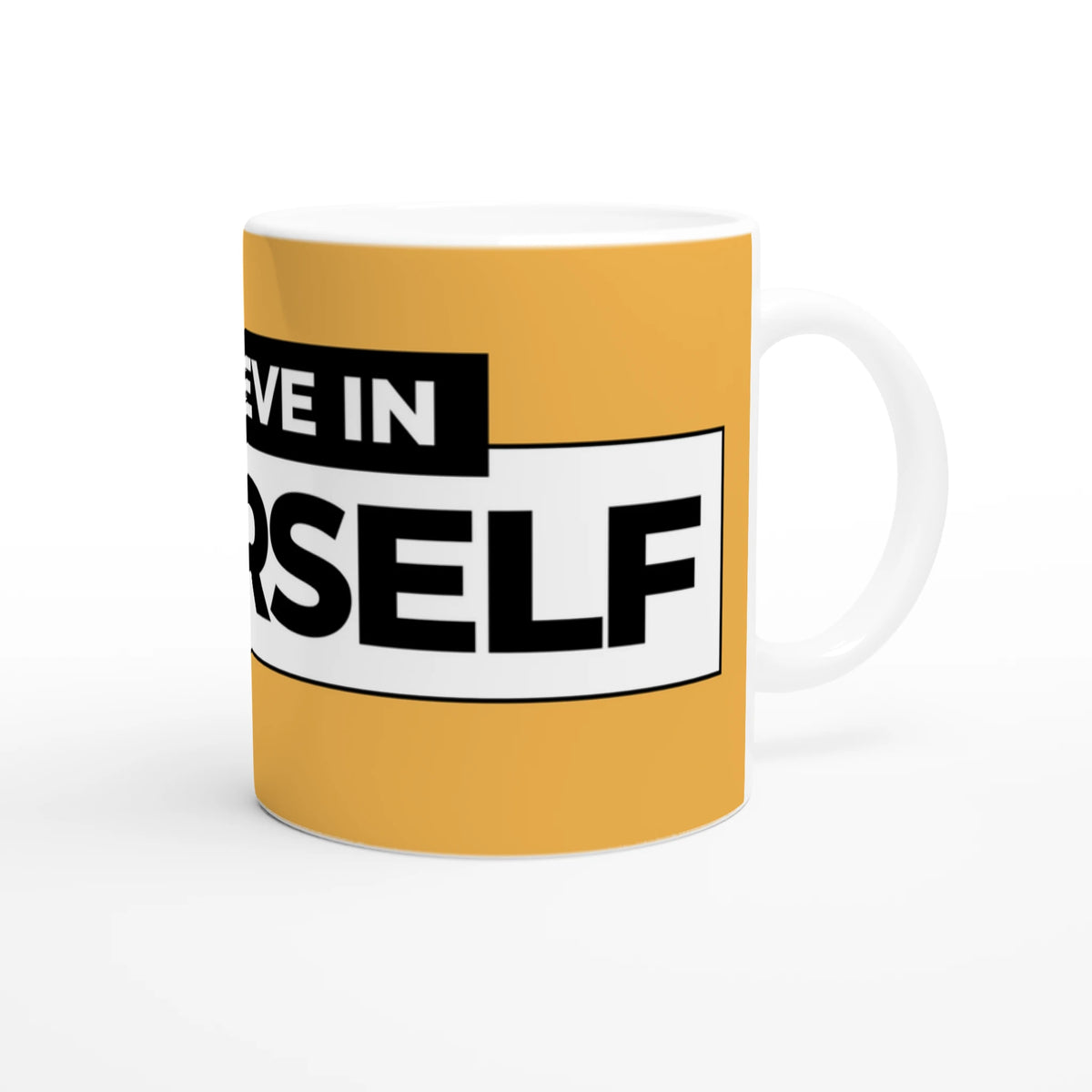 Cute Believe In Yourself mug with bold black-on-white slogan on orange ceramic cup.