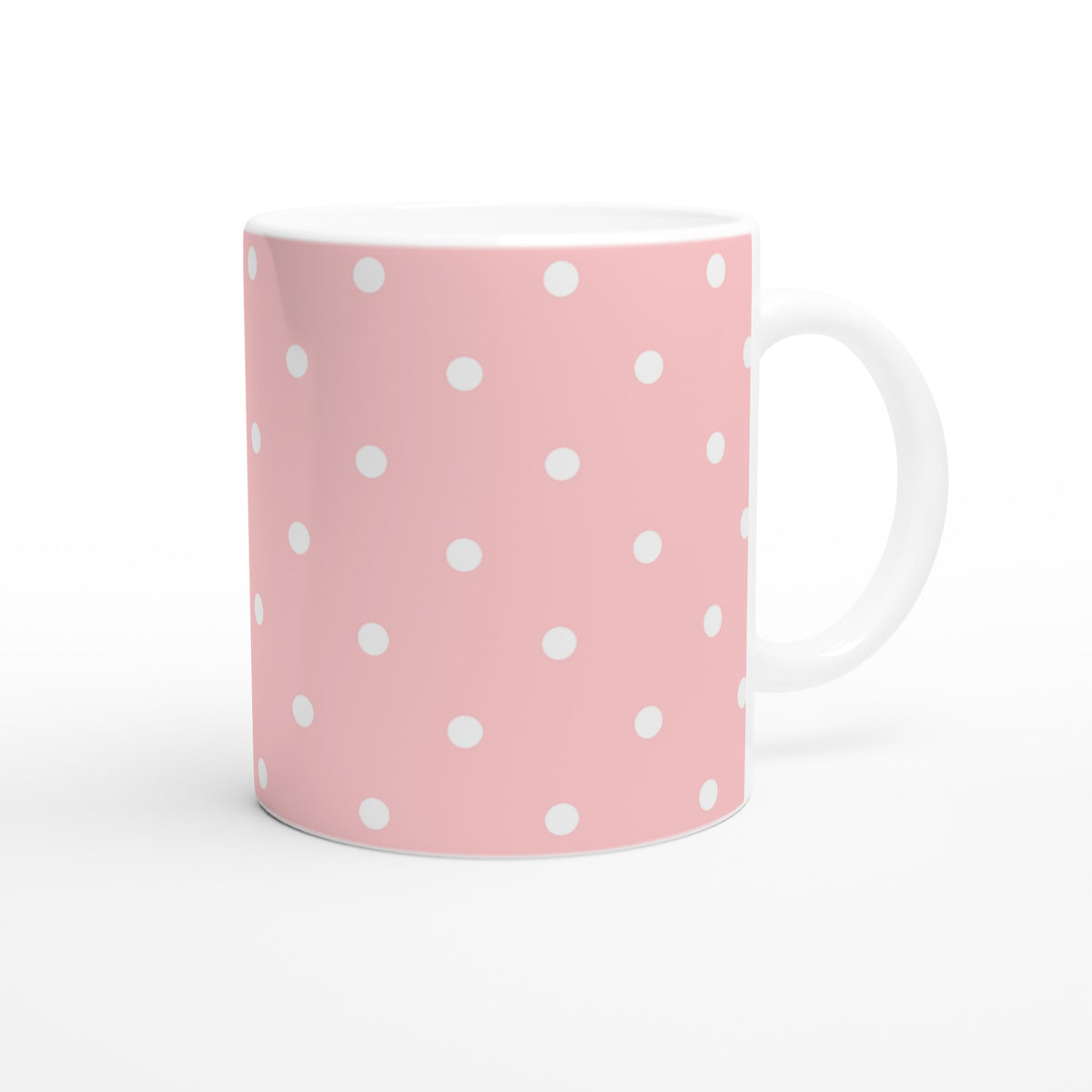 Pastel pink ceramic mug with white polka dots. Cute retro coffee cup ideal for daily coffee, tea, or gifting with a comfortable grip.