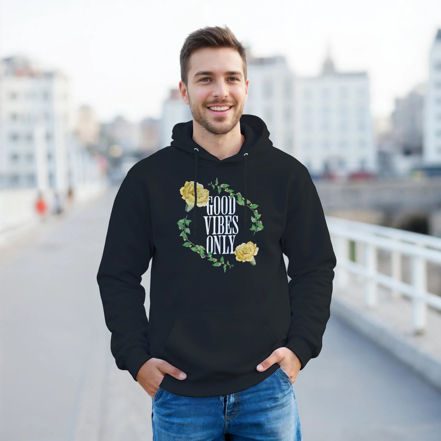Man in black 50/50 cotton-poly Good Vibes Only hoodie with floral wreath design and front pouch pocket.