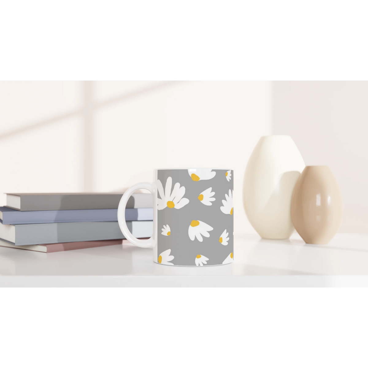 Ditsy Daisy Mug with white daisies on gray, a cute floral coffee cup for daily coffee or tea on a desk.