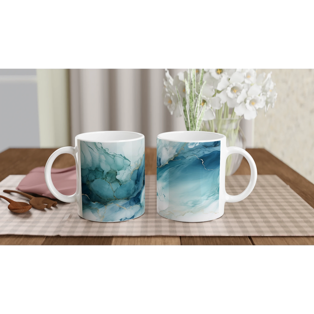 Blue marble ceramic mugs with an ocean-abstract glaze on a checkered table, white flowers in the background.