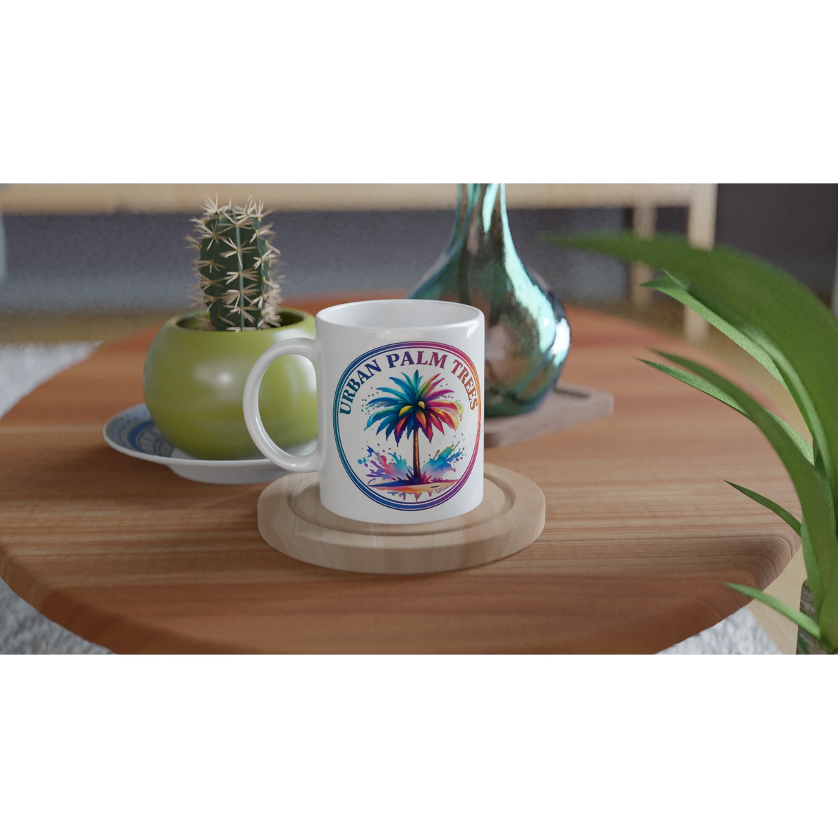 Urban Palm Trees mug with vibrant palm tree artwork on a wooden table beside a cactus.