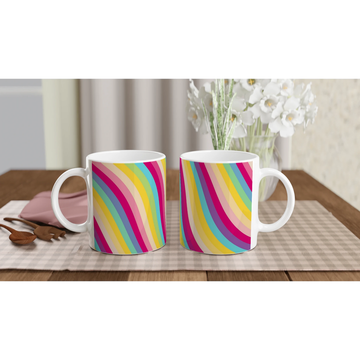 Retro Rainbow Stripe Ceramic Mugs - two colorful striped coffee cups on a wooden table with white flowers.