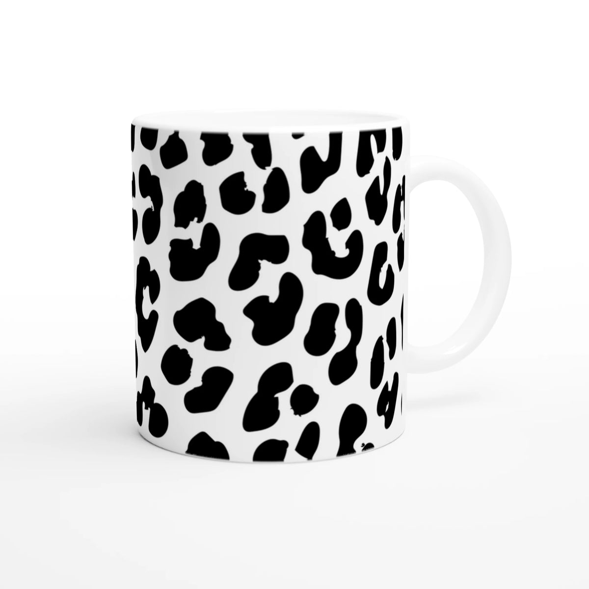 Retro Snow Leopard Mug with black leopard spots on white ceramic, animal aesthetic coffee cup.