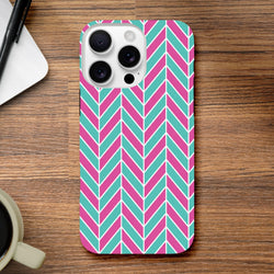 Pink and turquoise herringbone iPhone case on wooden desk. Geometric color-blocked phone cover with tough protective design for通勤 and home office.