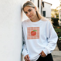 Retro orange gingham sweatshirt for women with a cute fruit graphic on the front.