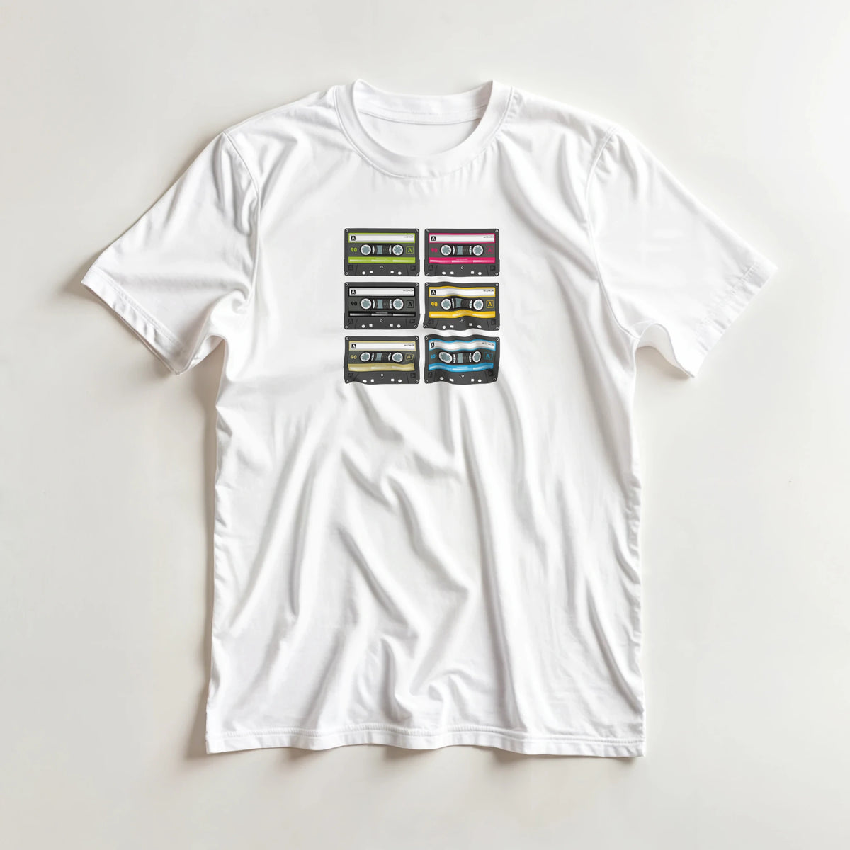 White women's tee with stacked colorful cassette tapes in a retro 80s music aesthetic.