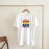 White Pride LGBTQ graphic T-shirt on hanger with rainbow flag and Peace & Pride text