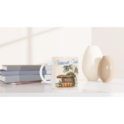 Retro postcard mug with island-themed artwork, white ceramic coffee cup on a clean desk.