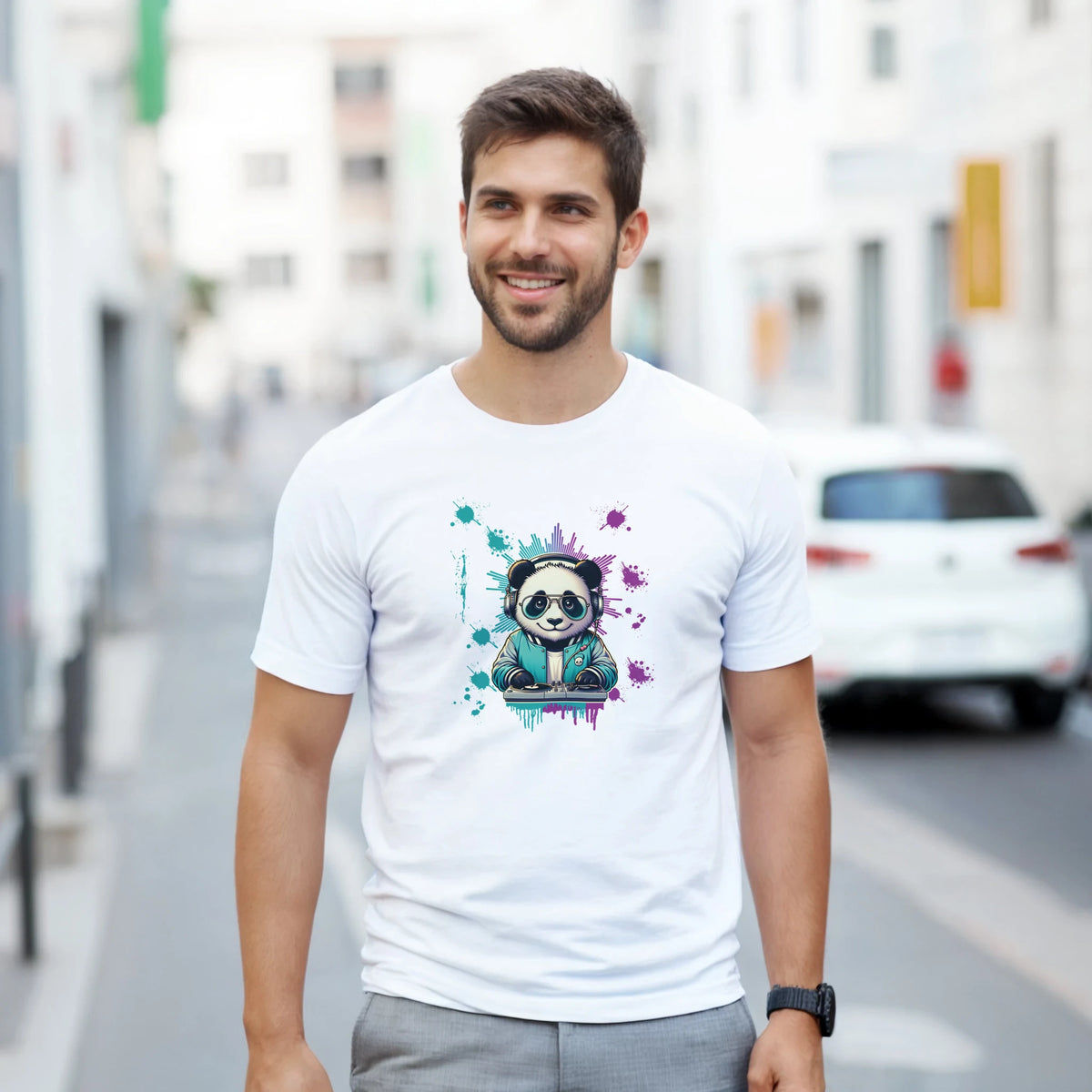 Man in white graphic T-shirt featuring a colorful panda DJ illustration, urban street backdrop.