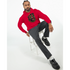 Man wearing red Grizzly Bear Hoodie with graphic design, seated on white stool, grey pants, black loafers.