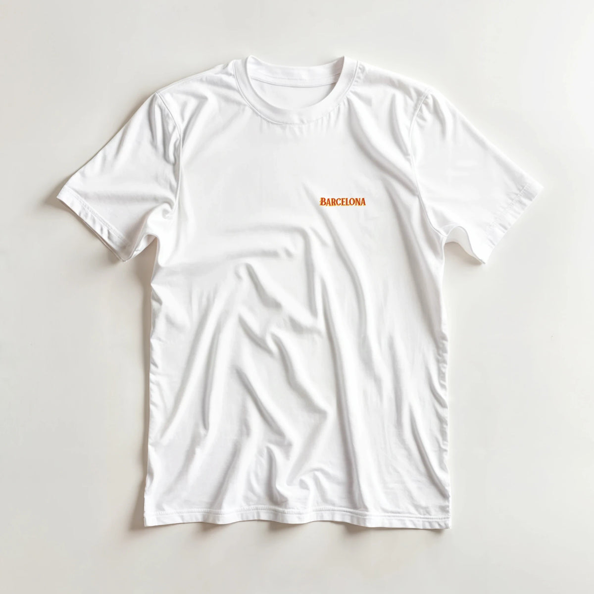 White Barcelona travel tee with small orange BARCELONA text on chest.