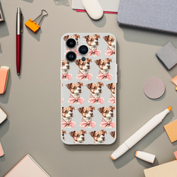 Slim transparent iPhone case with a repeating pattern of cute dogs wearing pink bows.