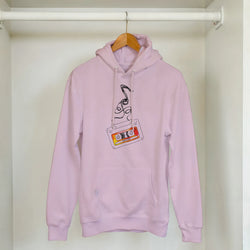 Pink hoodie featuring a retro cassette tape graphic with "90s Hits" label and swirling musical notes, hanging on a wooden hanger.