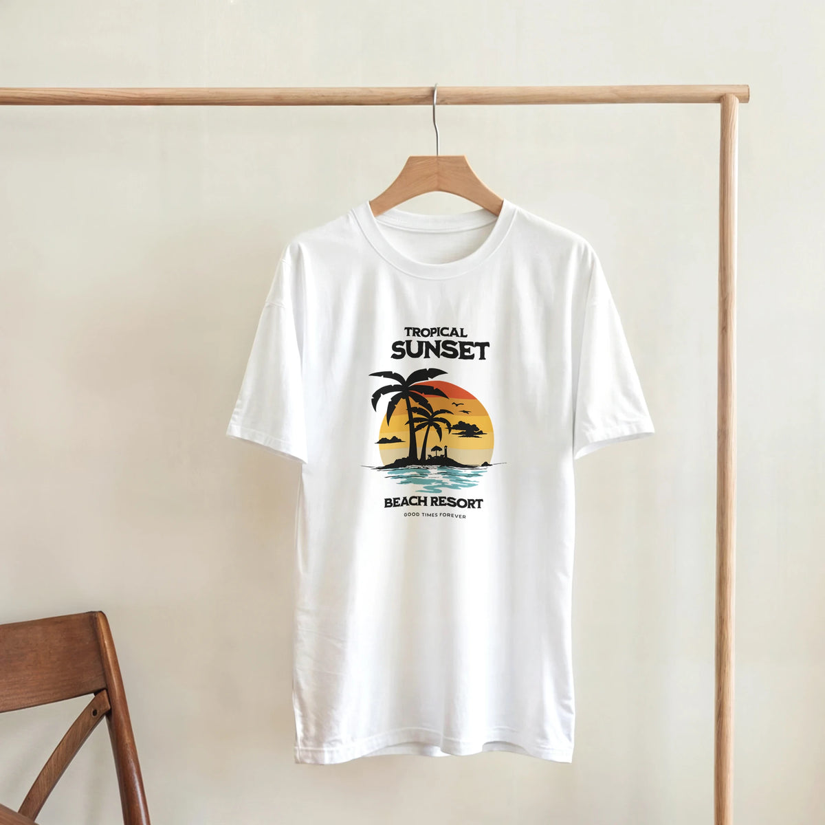 White t-shirt featuring a vintage tropical sunset graphic with palm trees and "Tropical Sunset Beach Resort" text.