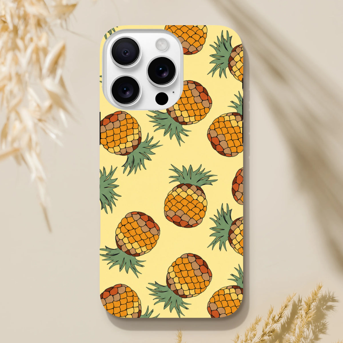 Yellow pineapple tropical iPhone case featuring a vibrant fruit pattern on a light background for impact protection.