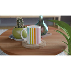 Rainbow Stripe Ceramic Mug with colorful vertical stripes on a wooden table, for daily coffee, surrounded by plants.