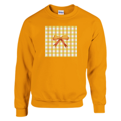Orange sweatshirt featuring a yellow gingham square graphic with a brown bow, embodying coquette aesthetic and vintage street style.