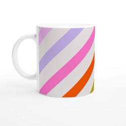 White ceramic mug with pastel diagonal rainbow stripes in pink, purple, and orange for coffee.