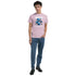 Man wearing pink Teddy Bear graphic T-shirt with blue bear design, crew neck, paired with blue jeans and black boots.