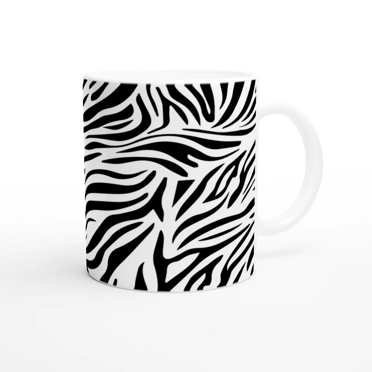 Black and white zebra print mug with bold animal pattern, ideal for coffee or tea.