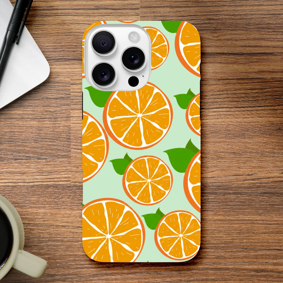 Cute orange fruit pattern phone case on mint background. Tough citrus iPhone cover with reinforced bumpers for drop protection.