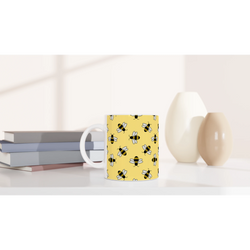 Cute yellow ceramic mug featuring a bee pattern, ideal for coffee or tea for bee lovers.