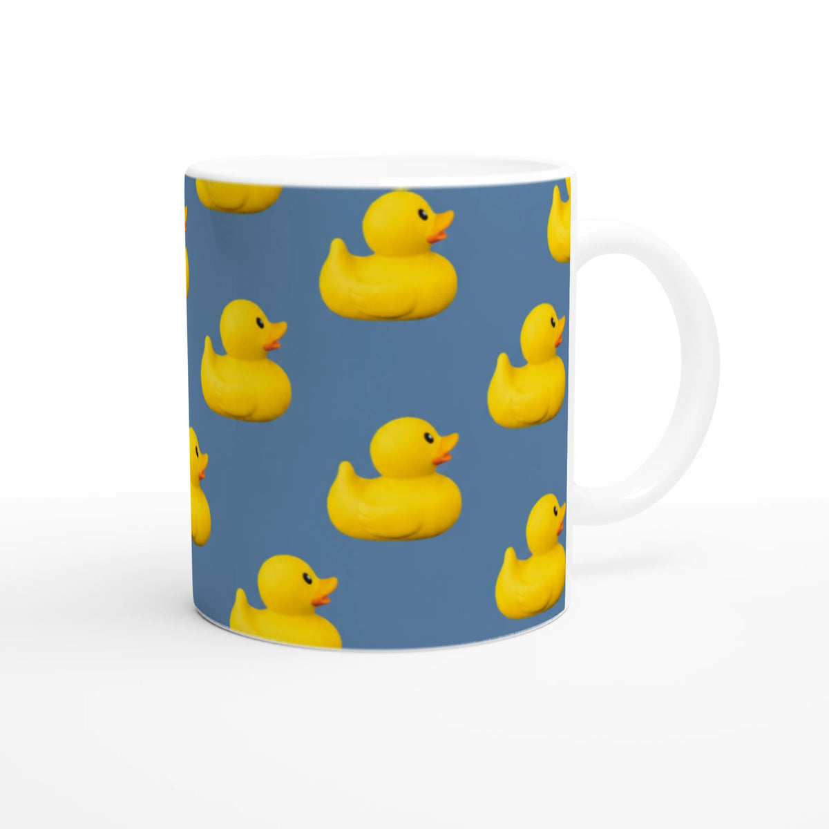 Blue rubber duck ceramic mug with yellow ducks pattern, a playful coffee cup.
