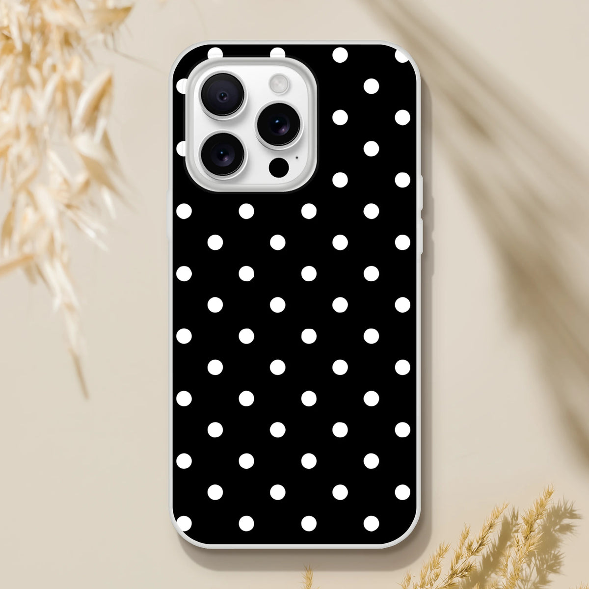 Retro black and white polka dot iPhone case with slim matte TPU protection and wireless charging compatibility for models 13-16.