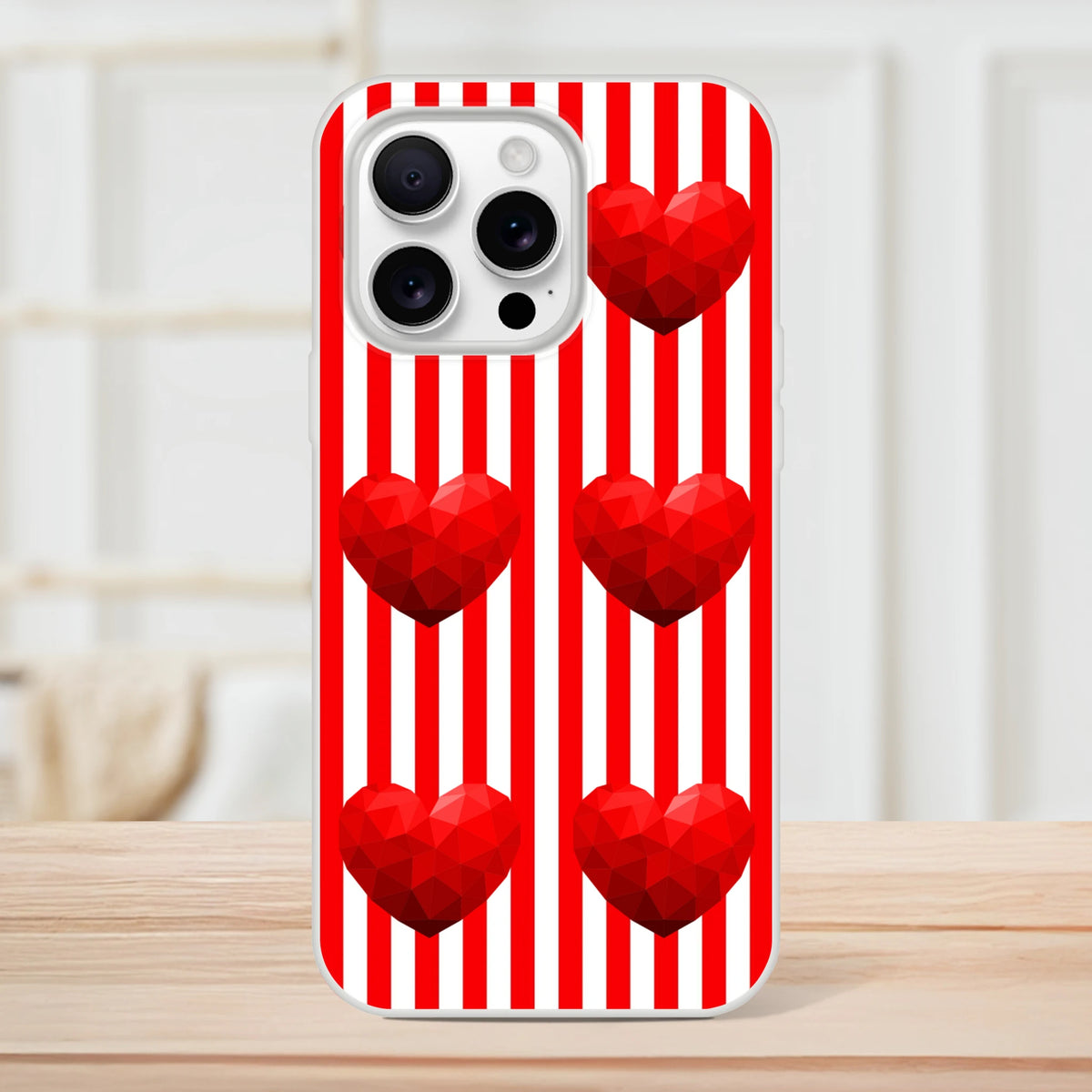 Red striped iPhone case with geometric red hearts on white background.