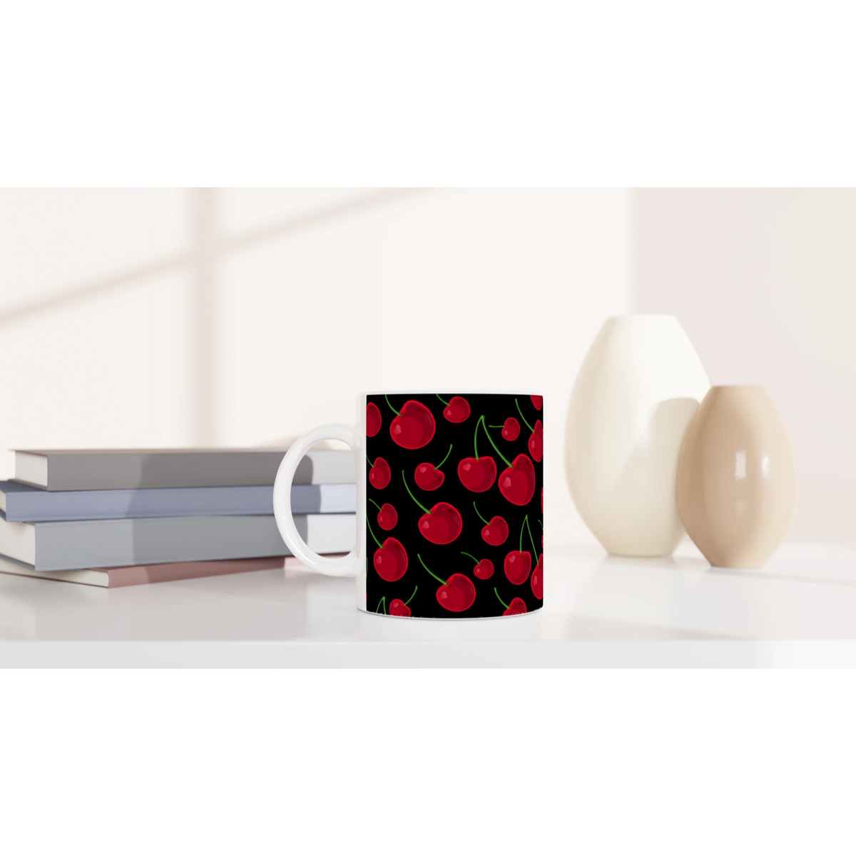 Vintage aesthetic ceramic coffee mug featuring a black background with a bright red cherry fruit pattern, sitting on a white desk.