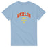Light blue Berlin graphic T-shirt with red BERLIN lettering and yellow 1994 Germany emblem on chest.