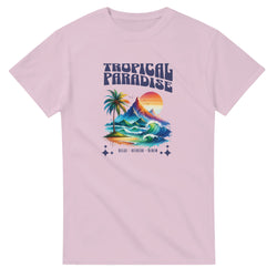 Pink shirt with Tropical Paradise graphic featuring palm tree, mountains, sun, and ocean waves.