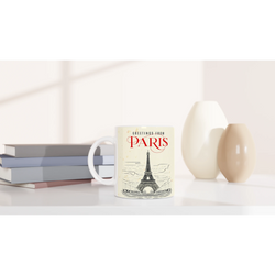 Vintage Paris mug featuring Eiffel Tower postcard design on a tidy desk with books.