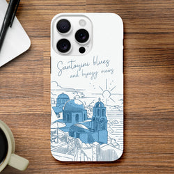 White iPhone case featuring a blue Santorini sky illustration with domed churches and "Santorini blues" script.