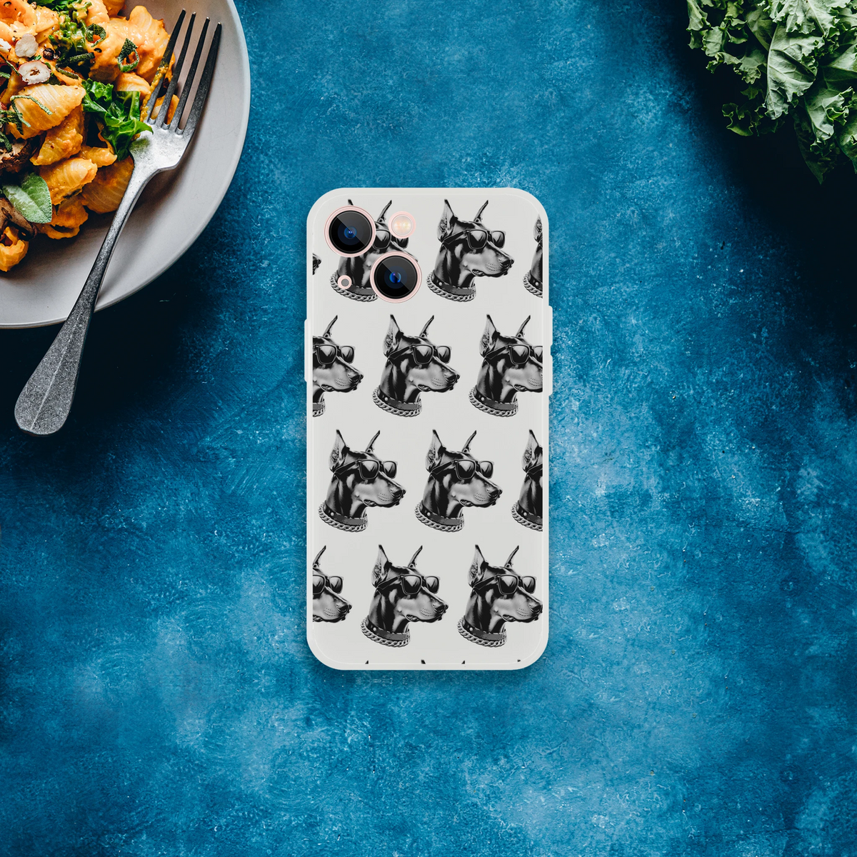 Gangster Dog iPhone case for 13-16, slim clear protective cover with repeating dog heads wearing sunglasses and chains.